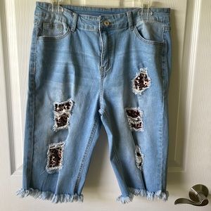 Womens denim shorts with animal print and fringe at bottom of shorts